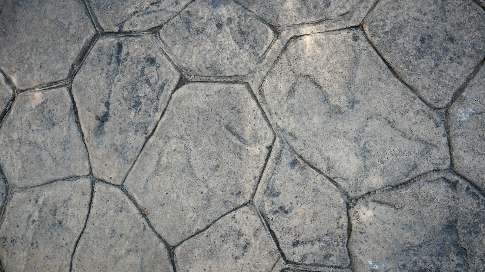 Grey random-flagstone pattern pressed into concrete