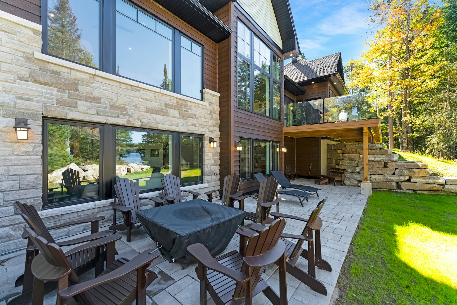 Stone-pattern patio with Adirondack chairs around a fire table