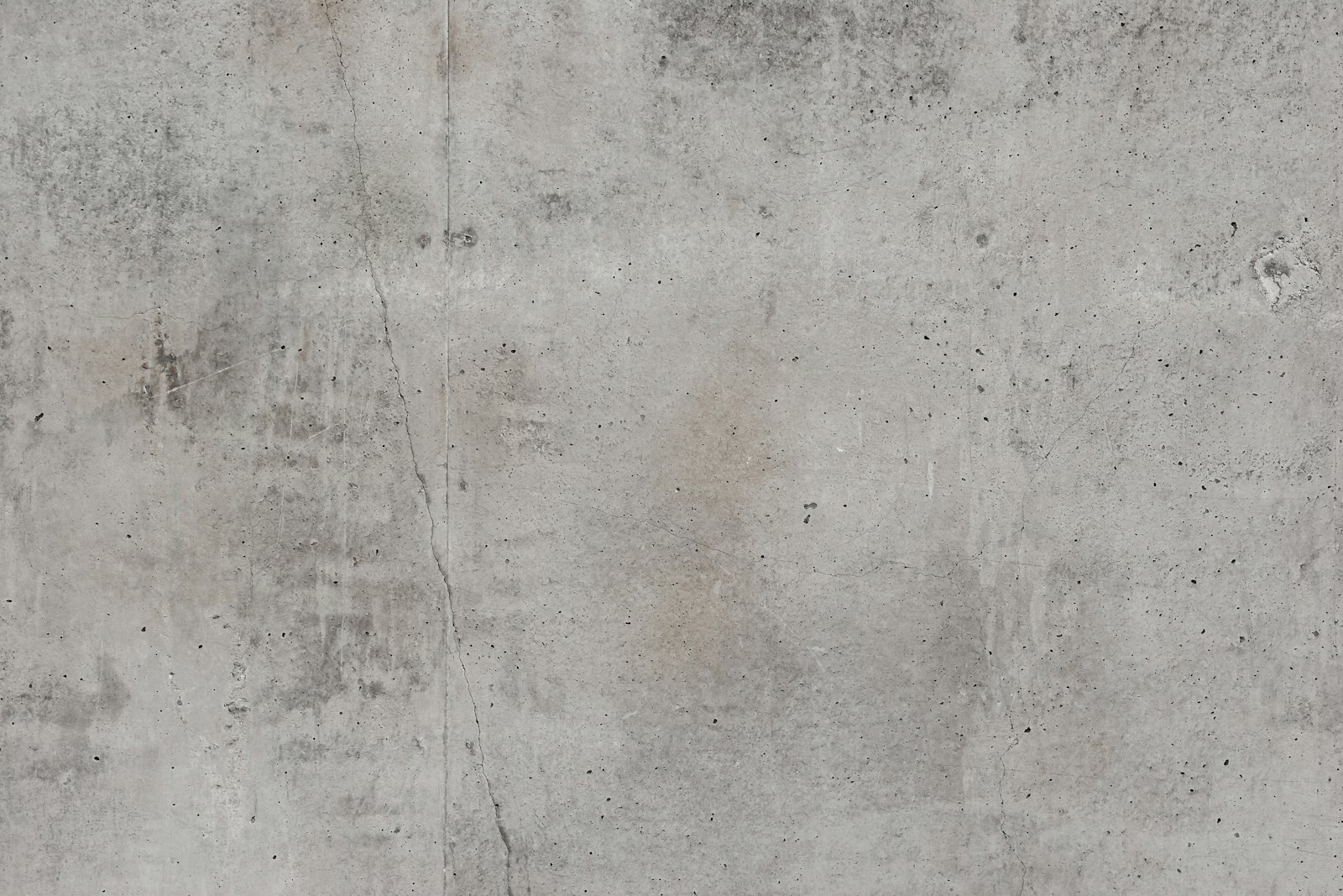 Grey concrete surface with hairline cracks